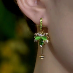 Model showcasing the dangle and style of the 14K Gold-Plated Zircon Green Cat's Eye Maple Leaf Earrings