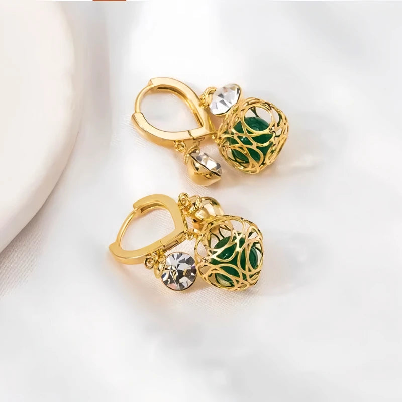 Model showcasing the dangle and style of the 14K Gold-Plated Zircon Green Crystal Ball White Diamond Earrings