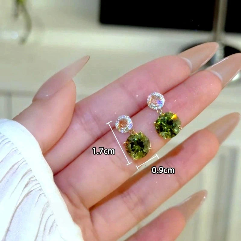 Model showcasing the dangle and style of the 14K Gold-Plated Zircon Green Diamond Water Drop Earrings