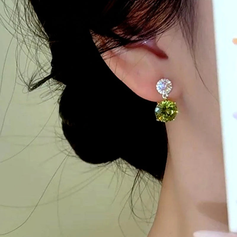 Close-up detail of the sparkling zircons and plating on the Green Teardrop Earrings