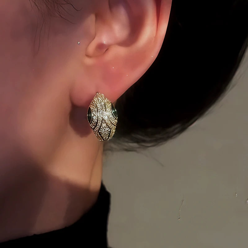 Close-up detail of the sparkling zircons and plating on the Green Eye Snake Hoops