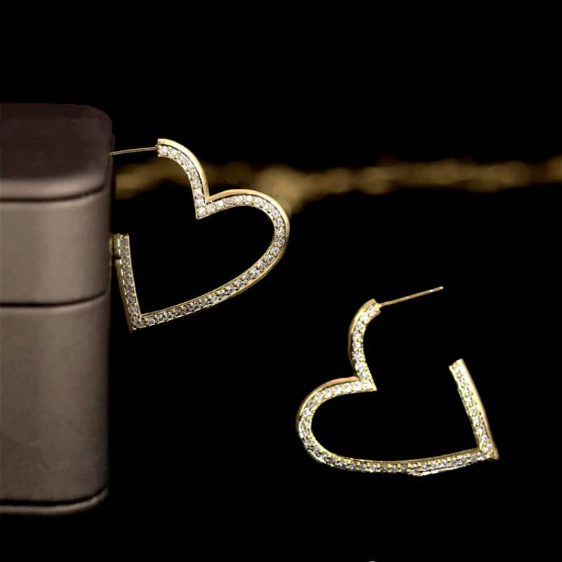 Model showcasing the dangle and style of the 14K Gold-Plated Zircon Heart-Design Earrings