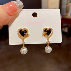 Angled view of the 14K Gold-Plated Zircon Heart-Shaped Pearl Earrings