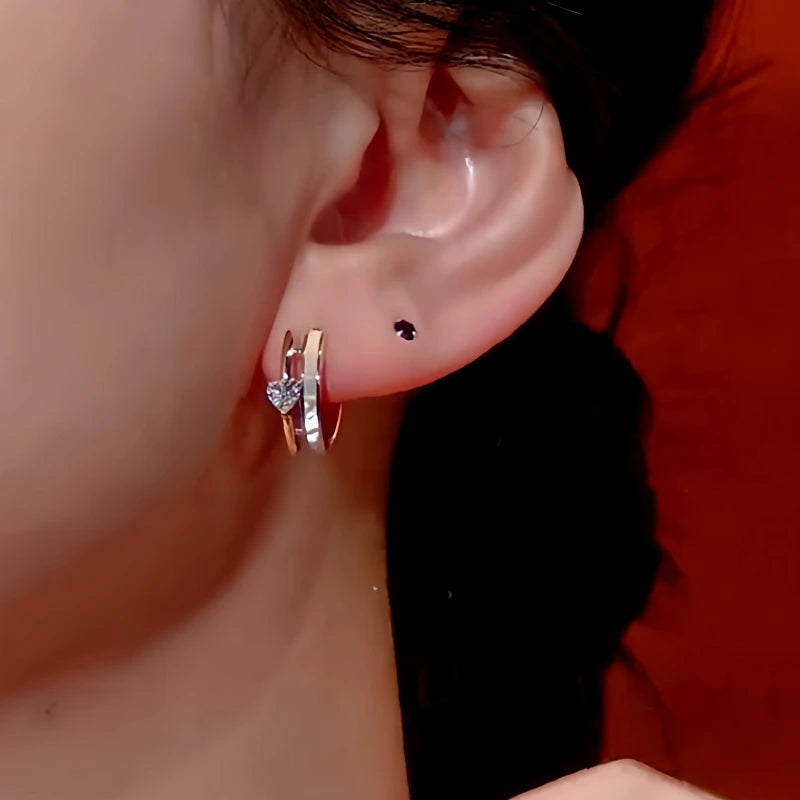 Close-up detail of the sparkling zircons and plating on the Heart Charm Hoops