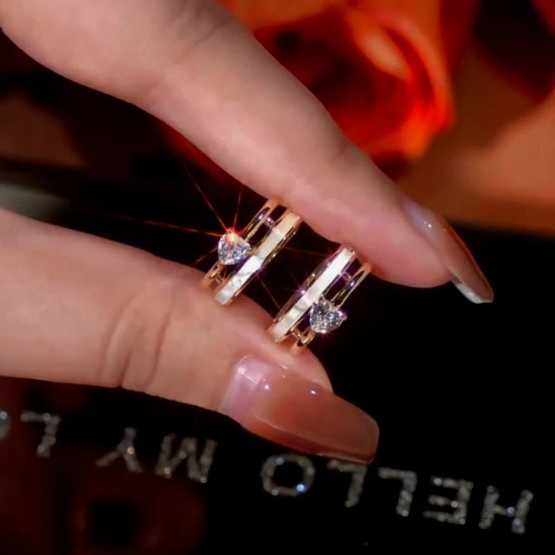 Angled view of the 14K Gold-Plated Zircon Heart Hoop Earrings