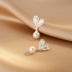 Angled view of the 14K Gold-Plated Zircon Heart Pearl Earrings