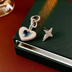 Angled view of the 14K Gold-Plated Zircon Heart Star Asymmetrical Earrings