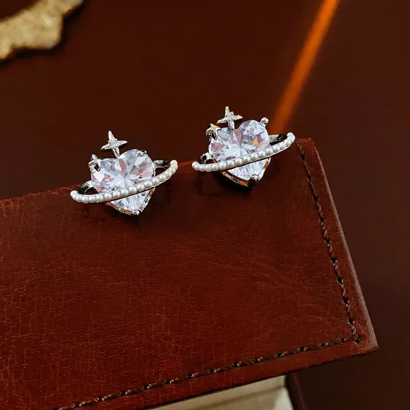 Model showcasing the dangle and style of the 14K Gold-Plated Zircon Heart Star Pearl Earrings