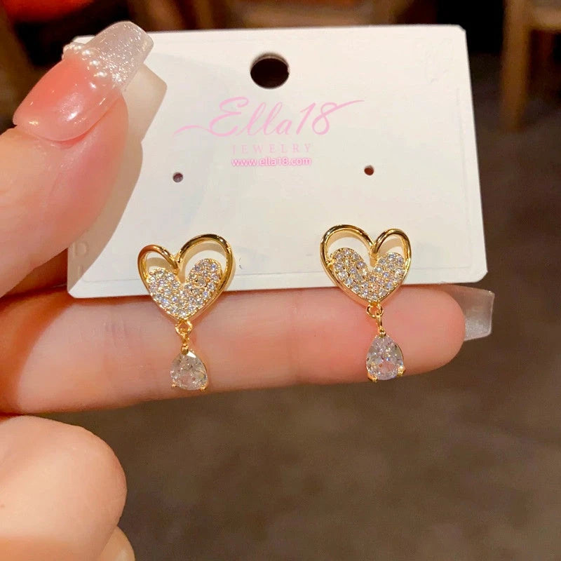 Angled view of the 14K Gold-Plated Zircon Heart Tassel Earrings