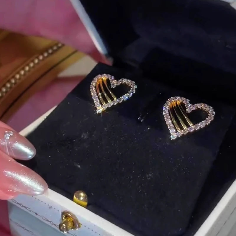 Angled view of the 14K Gold-Plated Zircon Hollow Heart Earrings