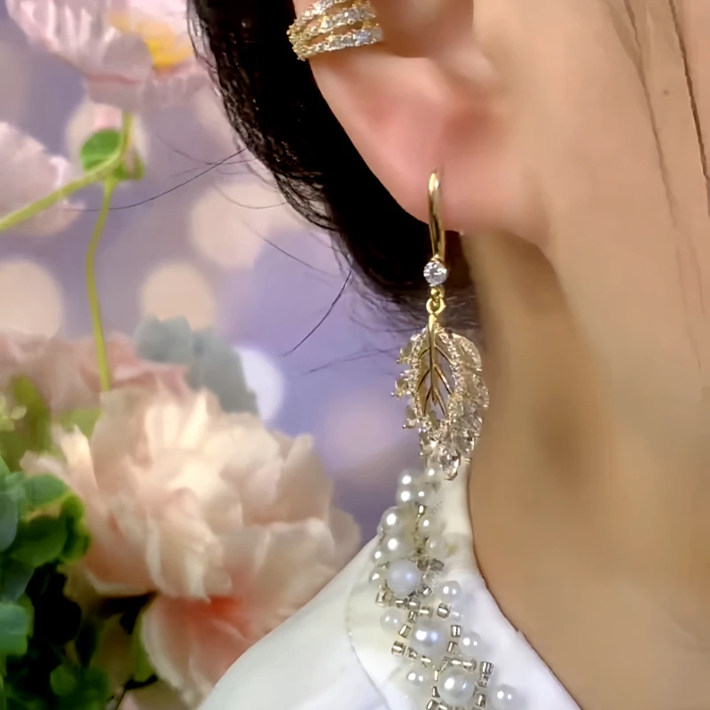 Model showcasing the dangle and style of the 14K Gold-Plated Zircon Hollow Leaf Ear Hooks