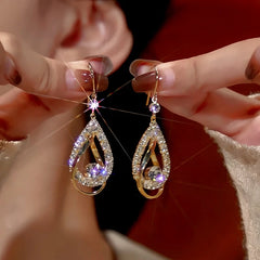 Model showcasing the dangle and style of the 14K Gold-Plated Zircon Hollow Water Drop Ear Hook Earrings