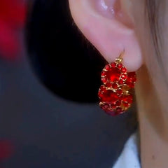 Close-up detail of the sparkling zircons and plating on the Red Heart Charm Hoops