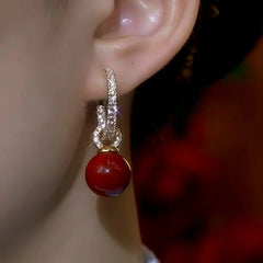 Close-up detail of the sparkling zircons and plating on the Red Bead Pearl Hoops