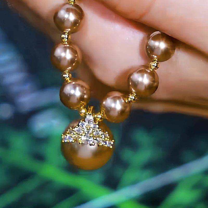 Detailed view of the 14K Gold-Plated Zircon Inlaid Champagne Pearl Necklace chain and pendant