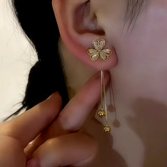 Model showcasing the dangle and style of the 14K Gold-Plated Zircon Inlaid Three-Leaf Flower Hanging Earrings