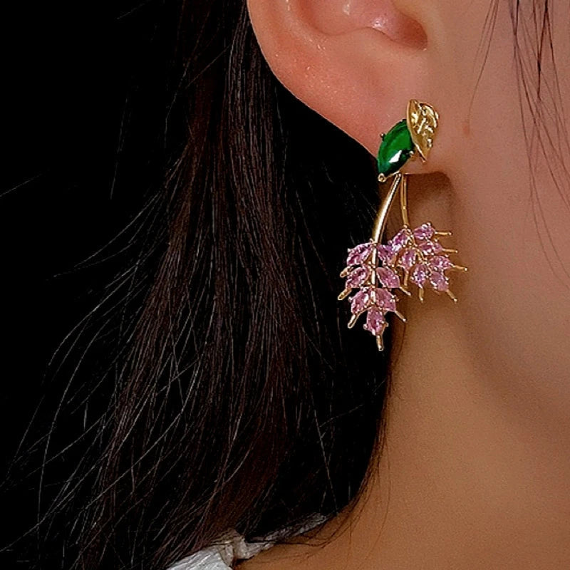 Model showcasing the dangle and style of the 14K Gold-Plated Zircon Leaf Earrings