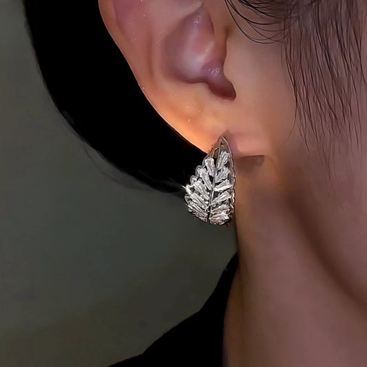 Model showcasing the dangle and style of the 14K Gold-Plated Zircon Leaf Earrings