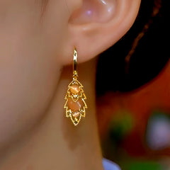 Model showcasing the dangle and style of the 14K Gold-Plated Zircon Leaf Earrings