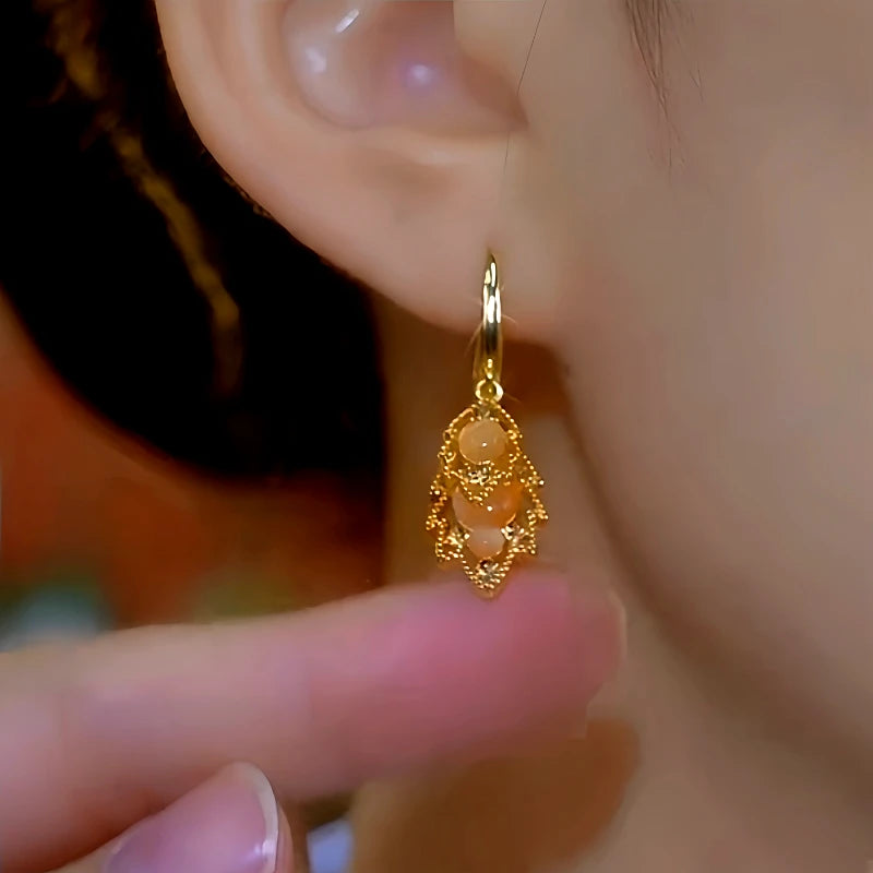 Close-up detail of the sparkling zircons and plating on the Olive Leaf Drops