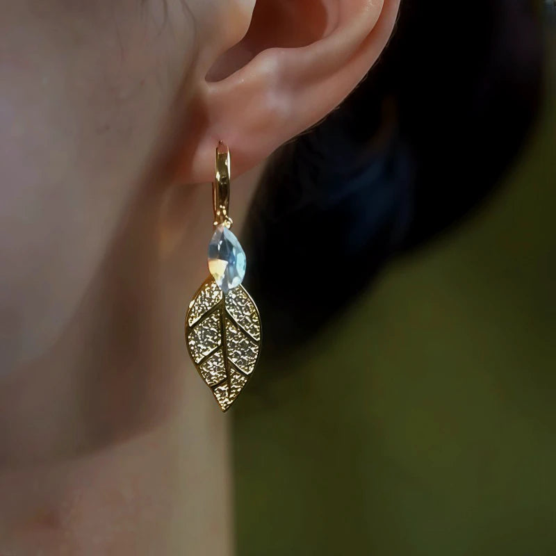 Model showcasing the dangle and style of the 14K Gold-Plated Zircon Leaf Earrings