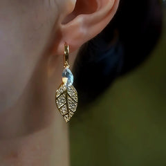 Model showcasing the dangle and style of the 14K Gold-Plated Zircon Leaf Earrings