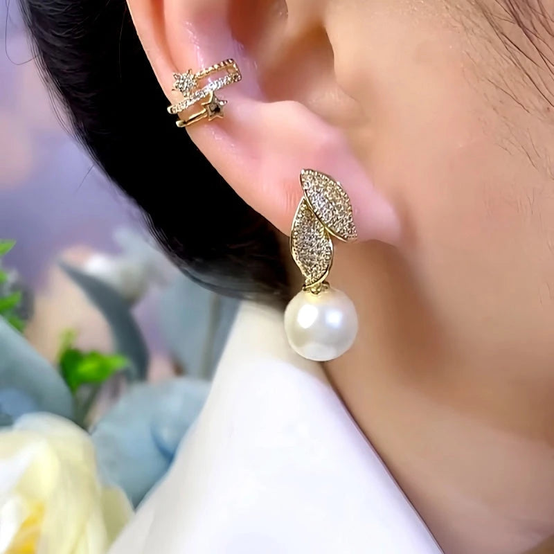 Model showcasing the dangle and style of the 14K Gold-Plated Zircon Leaf Pearl Earrings