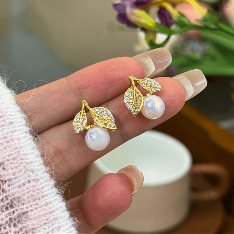 Angled view of the 14K Gold-Plated Zircon Leaf Pearl Earrings