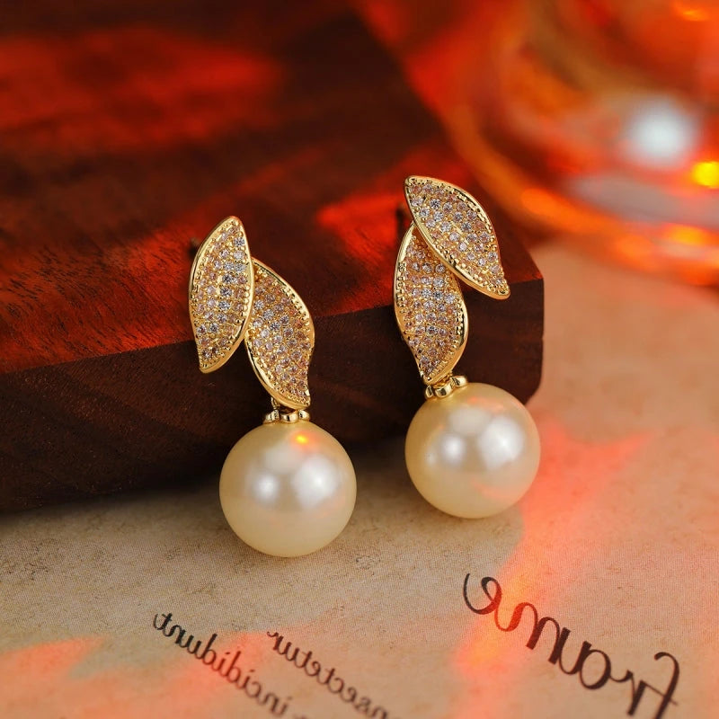 Angled view of the 14K Gold-Plated Zircon Leaf Pearl Earrings