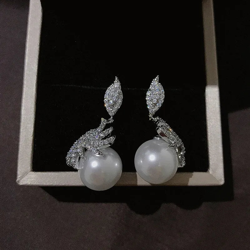 Angled view of the 14K Gold-Plated Zircon Leaf Pearl Earrings