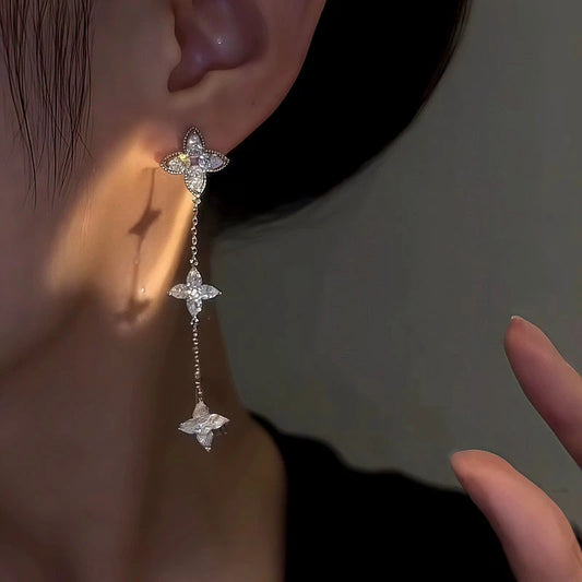 Model showcasing the dangle and style of the 14K Gold-Plated Zircon Leaf Tassel Earrings