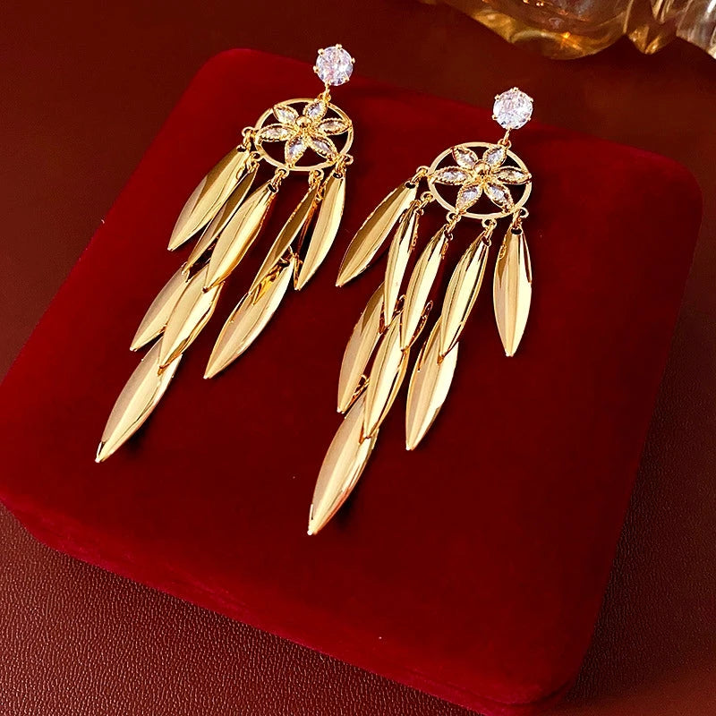 Angled view of the 14K Gold-Plated Zircon Leaf Tassel Earrings