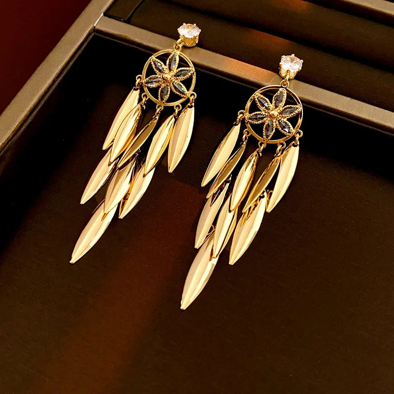 Model showcasing the dangle and style of the 14K Gold-Plated Zircon Leaf Tassel Earrings