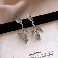 Angled view of the 14K Gold-Plated Zircon Leaf Tassel Earrings