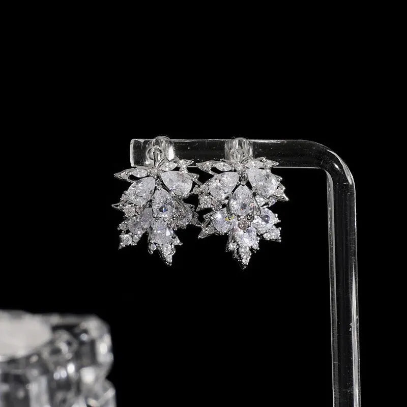 Angled view of the 14K Gold-Plated Zircon Maple Leaf Earrings