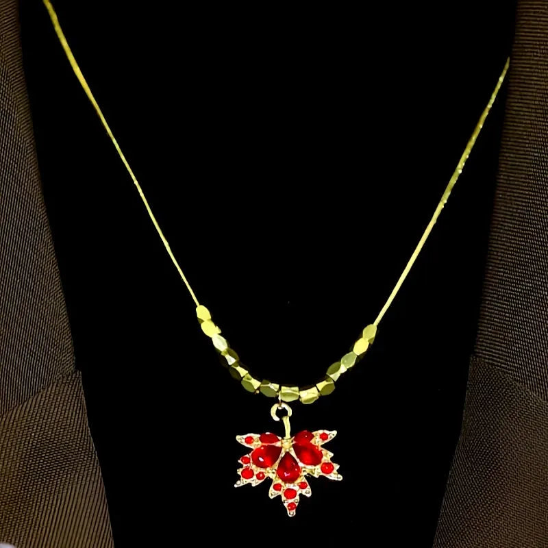 Close-up of the pendant and clasp on the Red Maple Leaf Necklace