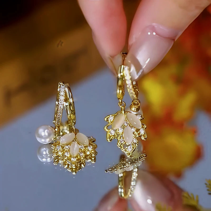 Angled view of the 14K Gold-Plated Zircon Maple Leaf Pearl Earrings