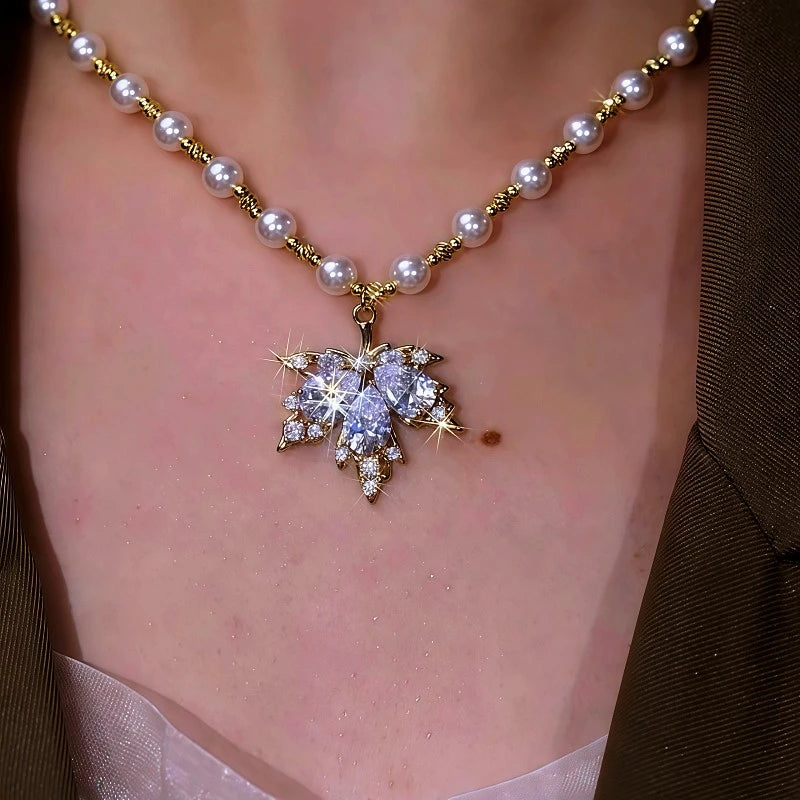 Detailed view of the 14K Gold-Plated Zircon Maple Leaf Pearl Necklace chain and pendant