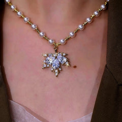 Detailed view of the 14K Gold-Plated Zircon Maple Leaf Pearl Necklace chain and pendant