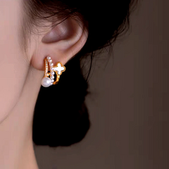 Model showcasing the dangle and style of the 14K Gold-Plated Zircon Multi-Layer Four-Leaf Flower Pearl Earrings