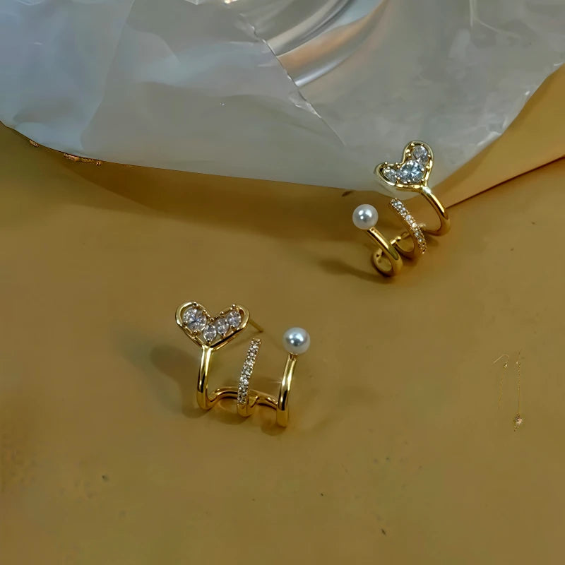 Model showcasing the dangle and style of the 14K Gold-Plated Zircon Multi-Layer Heart Pearl Stud Earrings