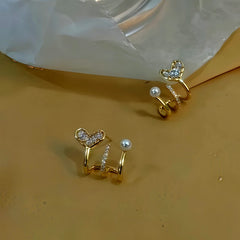 Model showcasing the dangle and style of the 14K Gold-Plated Zircon Multi-Layer Heart Pearl Stud Earrings