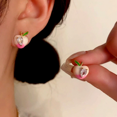 Angled view of the 14K Gold-Plated Zircon Oil Drop Peach Stud Earrings