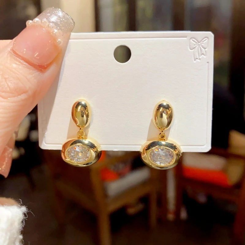 Close-up detail of the sparkling zircons and plating on the Golden Oval Hoops