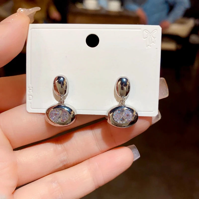 Angled view of the 14K Gold-Plated Zircon Oval Earrings