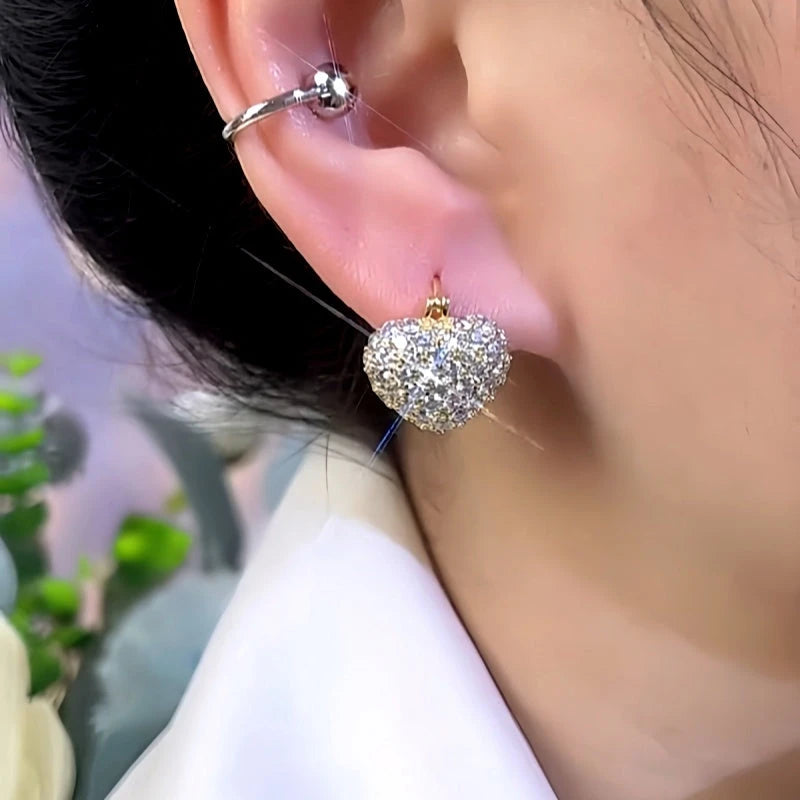 Model showcasing the dangle and style of the 14K Gold-Plated Zircon Pearl Double-Sided Heart Earrings