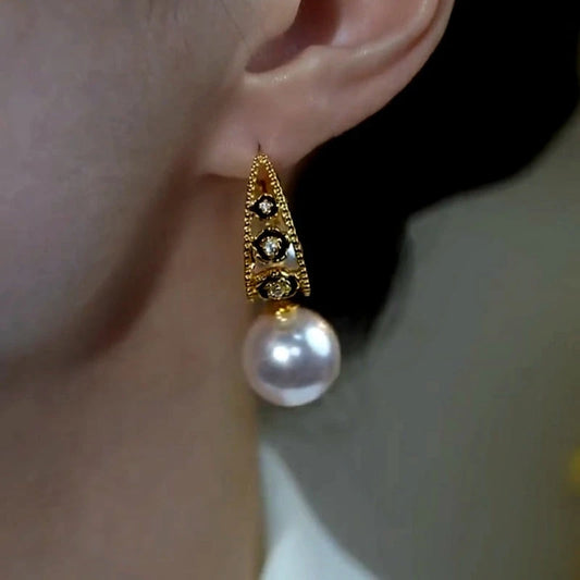 Model showcasing the dangle and style of the 14K Gold-Plated Zircon Pearl Earrings