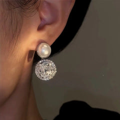 Model showcasing the dangle and style of the 14K Gold-Plated Zircon Pearl Earrings