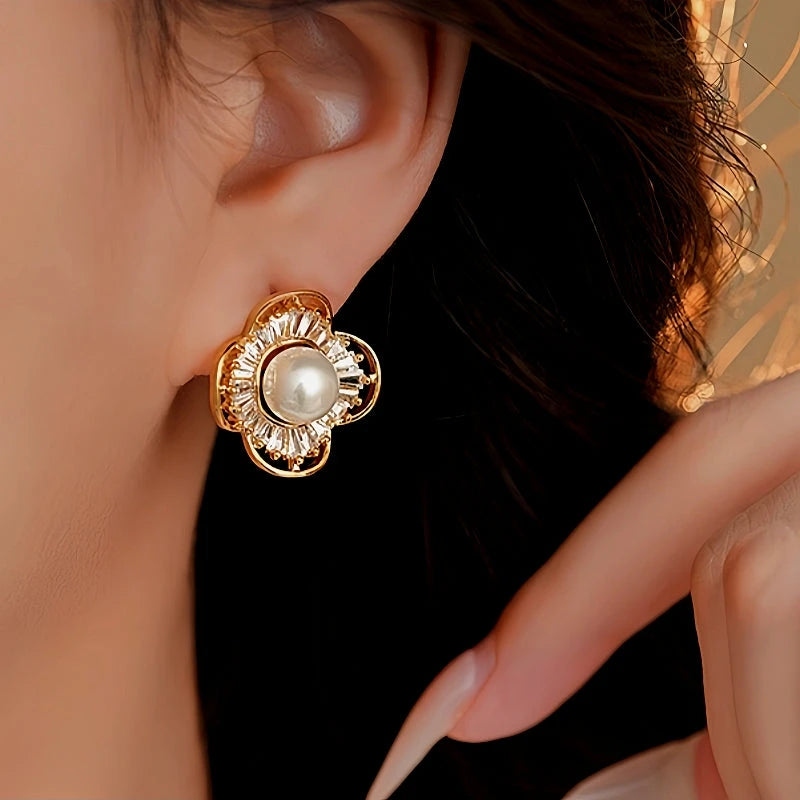 Model showcasing the dangle and style of the 14K Gold-Plated Zircon Pearl Flower Stud Earrings