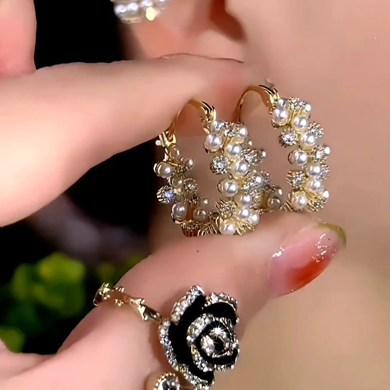 Close-up detail of the sparkling zircons and plating on the Pearl Hoop Earrings
